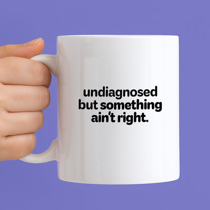 Kubek z nadrukiem - "undiagnosed but something ain't right"