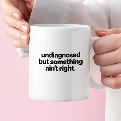 Kubek z nadrukiem - "undiagnosed but something ain't right"