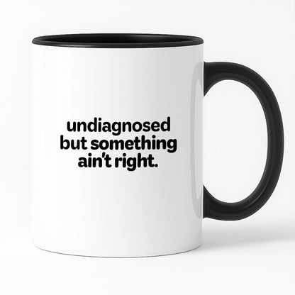 Kubek z nadrukiem - "undiagnosed but something ain't right"