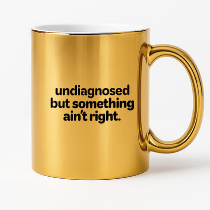 Kubek z nadrukiem - "undiagnosed but something ain't right"