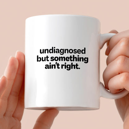 Kubek z nadrukiem - "undiagnosed but something ain't right"