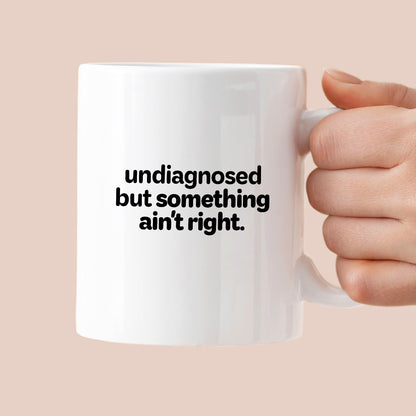 Kubek z nadrukiem - "undiagnosed but something ain't right"